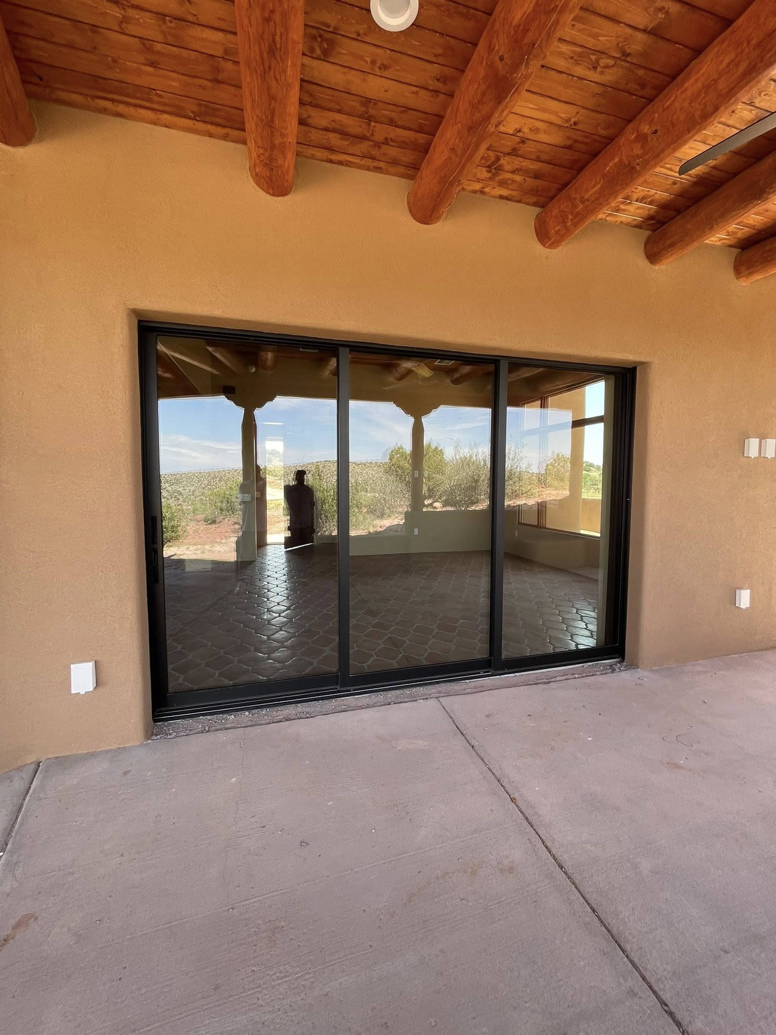 3-panel sliding glass door on adobe style New Mexico home